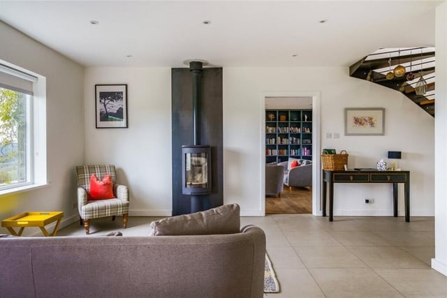 This sitting space has a modern, multi-fuel stove.
