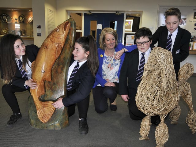 Headteacher Sue Whelan and Eskdale School pupils are pictured with sculptures by Steve Iredale and Emma Stothard.