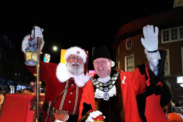 Santa arrives at last year's Christmas lights switch-on with Councillor Rick Arrand.