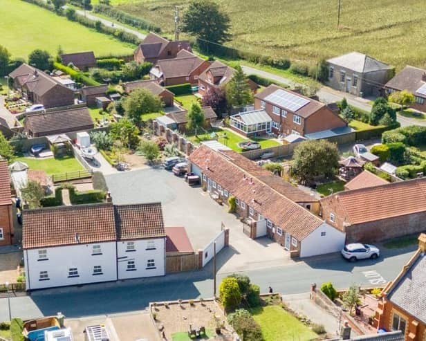 An aerial view displaying the layout of house and gardens, holiday cottages and office.