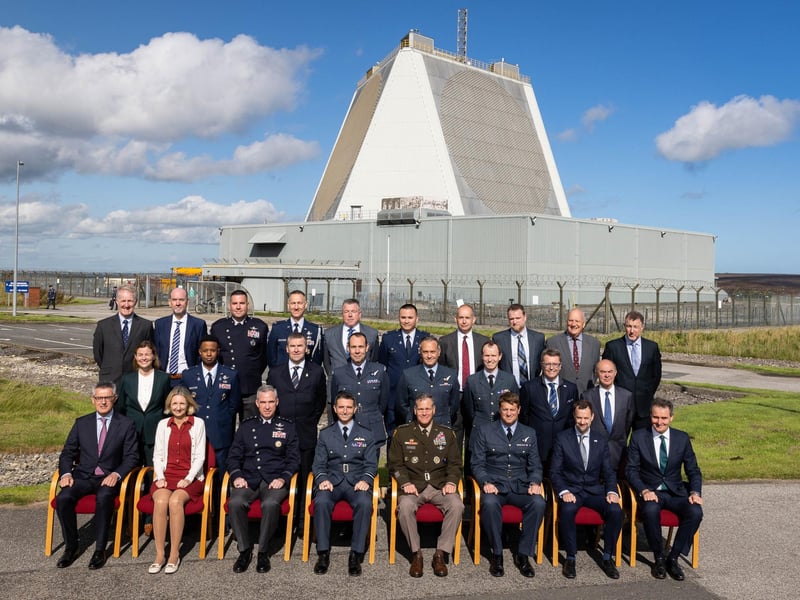 VIP visitors with the Stn Cdr posed outside of the SSPAR (Solid-State Phased Array Radar).