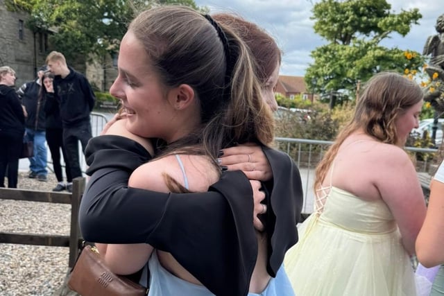 Hugs for friends at the end of year party.