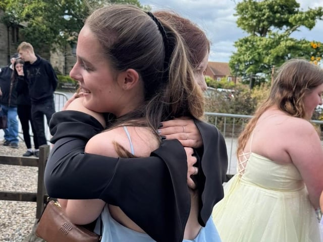 Hugs for friends at the end of year party.