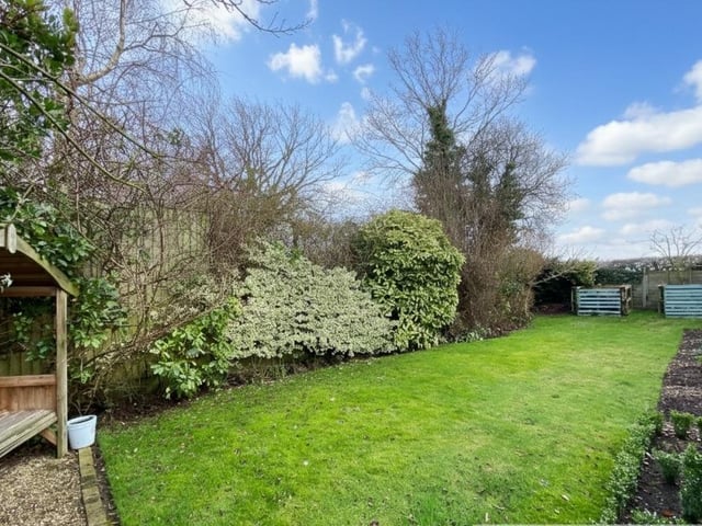 A mature enclosed garden with planted borders adds to the allure of the cottage.