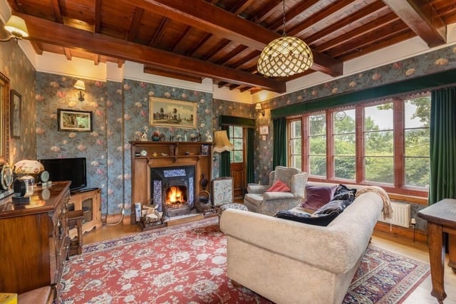 A lovely, bright reception room has a feature cast fireplace, with tiling and oak surround.