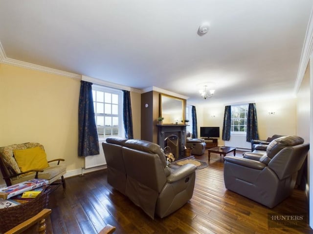 A double aspect sitting room with a feature fireplace.
