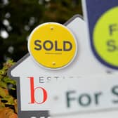 File photo of a sold and for sale signs.