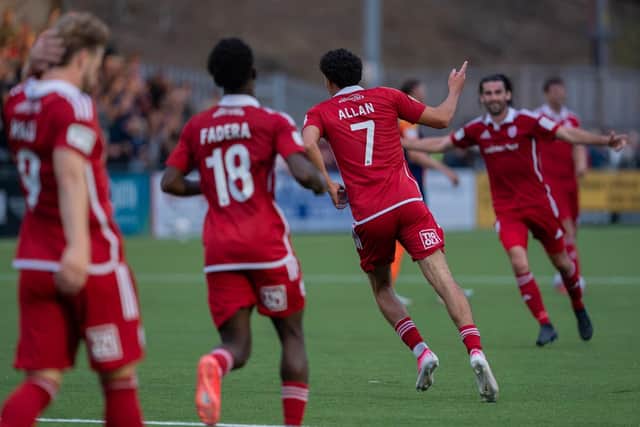 Star man Rio Allan celebrates with his team-mates. Photo by Wandering Photography