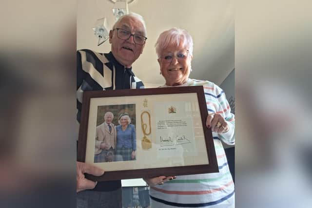 Jenny and Roy Baldwin with their congratulatory message from the King.