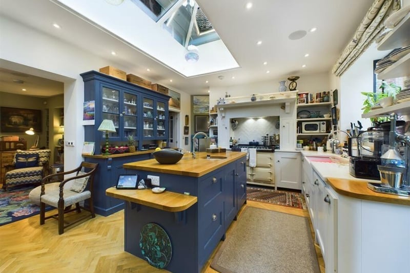 The bespoke kitchen with central island has a lantern ceiling feature.