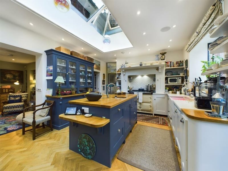 The bespoke kitchen with central island has a lantern ceiling feature.