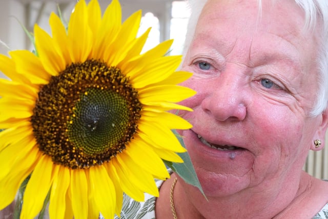 Chair Sue Butler with a lovely sunflower