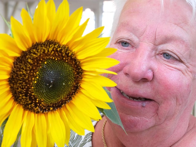 Chair Sue Butler with a lovely sunflower