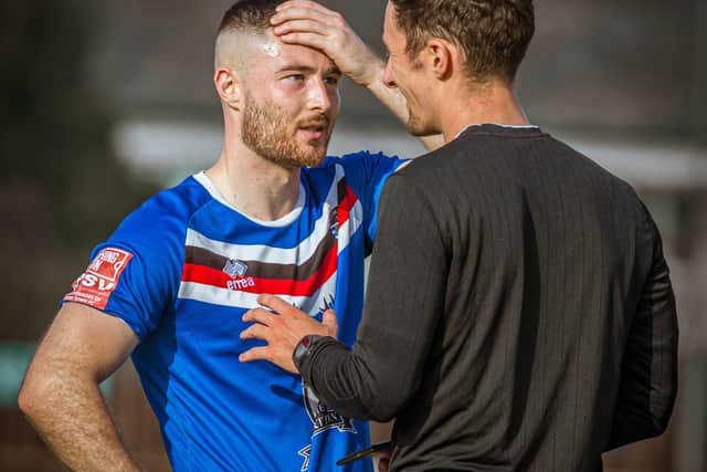 Whitby Town striker Brad Fewster shows his disbelief as he's booked.