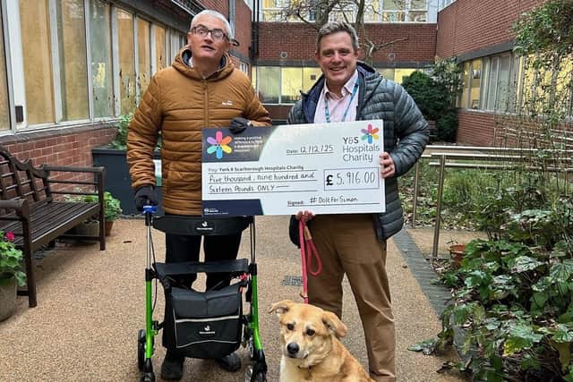 Simon Middleton presents a cheque to the York and Scarborough Hospitals Charity.