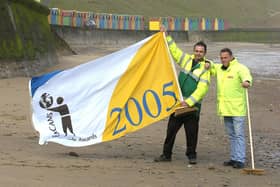 Whitby beach and facilities receives a 2005 ENCAMS seaside award. Flying the flag are Scarborough Borough Council employees Ged McCourt, left, and Don Buckley.