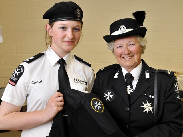 Scarborough St John Ambulance celebrating its centenary, at Falsgrave Community Centre. Scarborough Cadet and Graham School pupil Sarah Hunter, 15, is presented with her Gold Award by County President Elise MacKinley. 103716b
