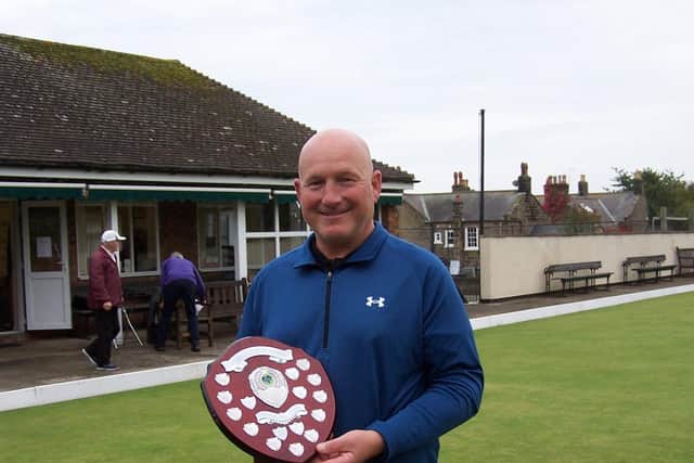Alan Landers with the Champions of Champions trophy.