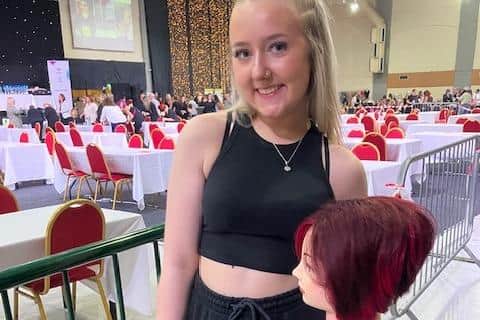 Demi Barron holding a training head.
