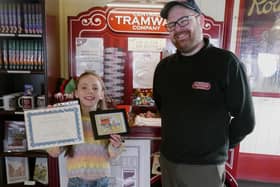 Anya Moore with her winning postcard, standing with Colin Powell, The General Manager of Central Tramway Company.