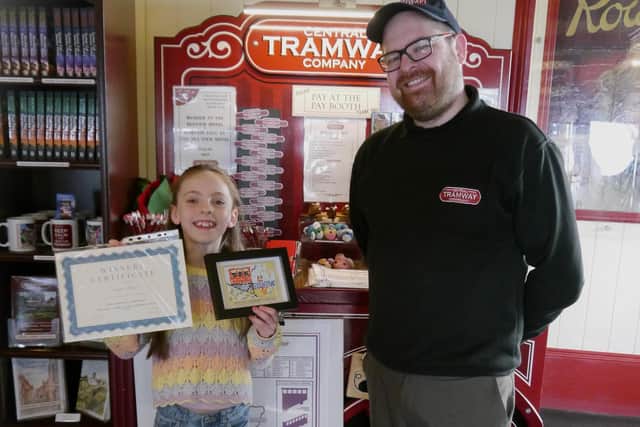 Anya Moore with her winning postcard, standing with Colin Powell, The General Manager of Central Tramway Company.