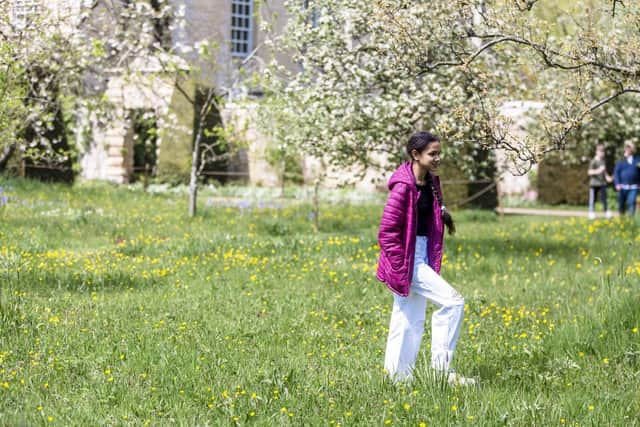 Visitros exploring the garden during the Festival of Blossom event at Nunnington Hall, North Yorkshire