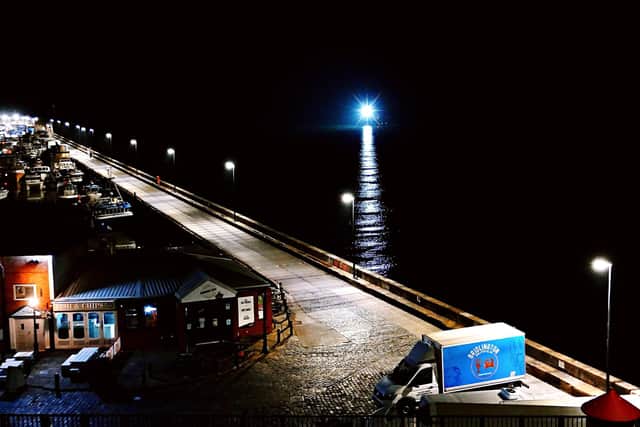 A fishing boat returns, by Aled Jones.