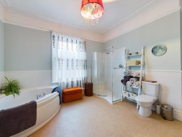 A bathroom with both a shower and a corner bath.