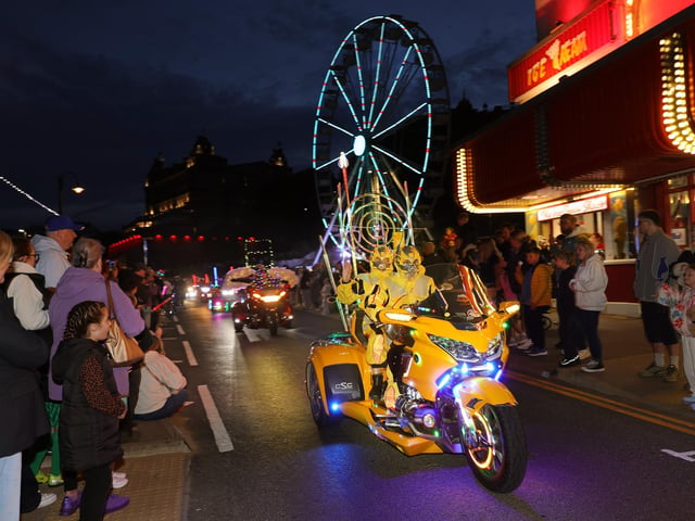 Families looking at the lit-up bikes. photo: Richard Ponter