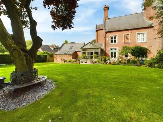 A view of the country home from its extensive rear garden.