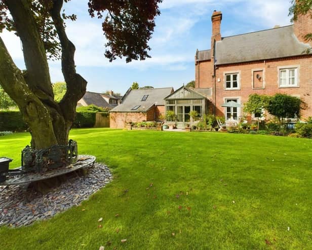 A view of the country home from its extensive rear garden.
