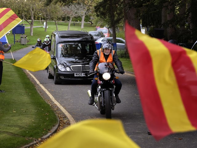 An orange army guard of honour awaited Mr Emmerson's coffin
