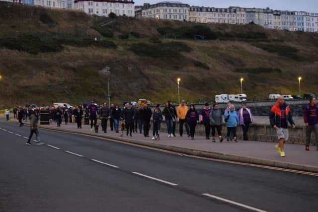 Walkers enjoying their stroll as the sun sets.