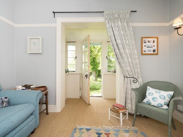 This plush reception room has comfy sofas and direct access to the stunning gardens.