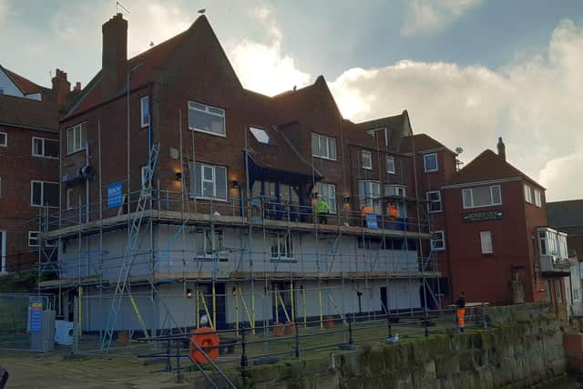 Scaffolders working on the Duke of York pub in Whitby, which is currently closed.
