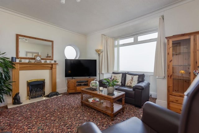 This sea-facing sitting room has a feature fireplace with living flame gas fire.