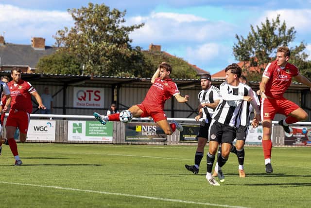 New Brid signing Jacob McLoughlin reaching for the ball at Ashington. Photo by EC Media