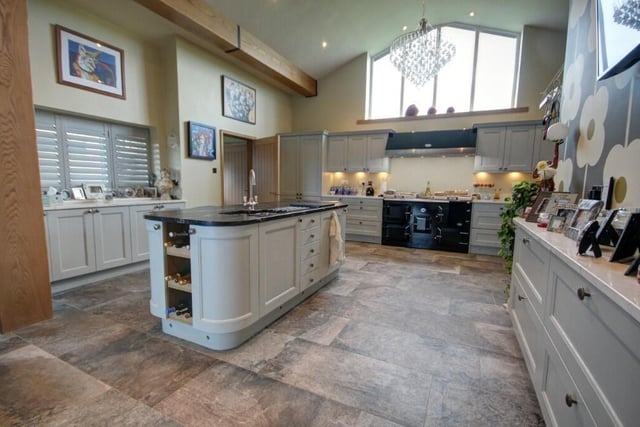 A stunning 'cathedral style' kitchen with a central island.