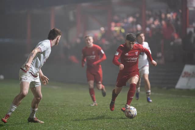 Defender Alex Brown brings the ball upfield against National League North leaders South Shields. Photo by Wandering Photography
