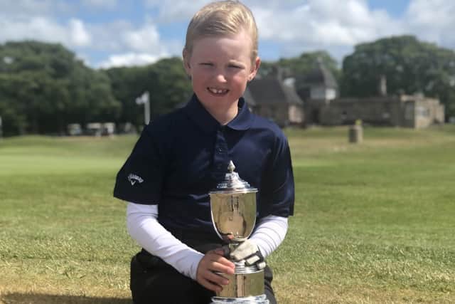 George Rowell, 7, with the US Kids European Championship runners-up trophy.