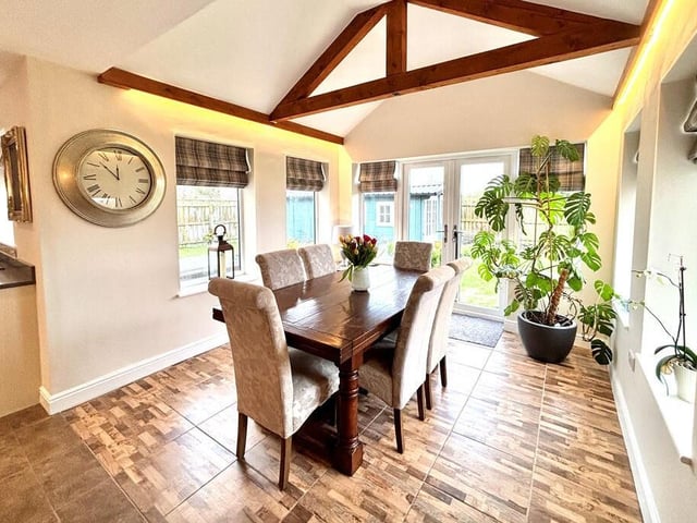 The dining room, with open vaults to the ceiling, has doors leading outside.