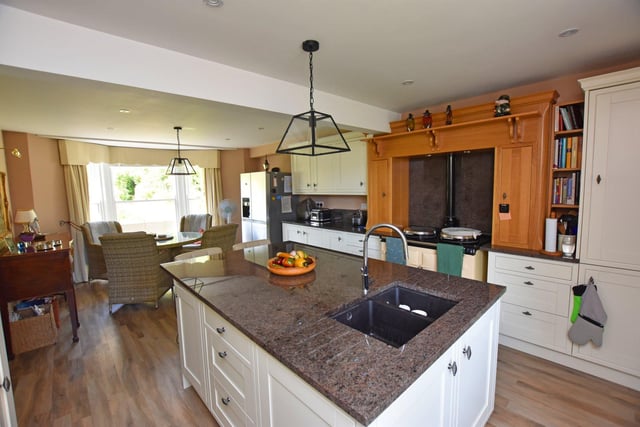The bright kitchen with dining area features a central island.