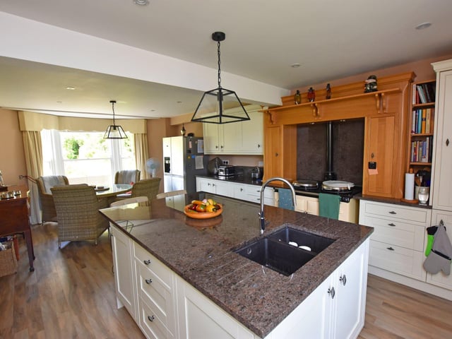 The bright kitchen with dining area features a central island.