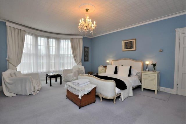 A large and light bedroom with stunning bay window.