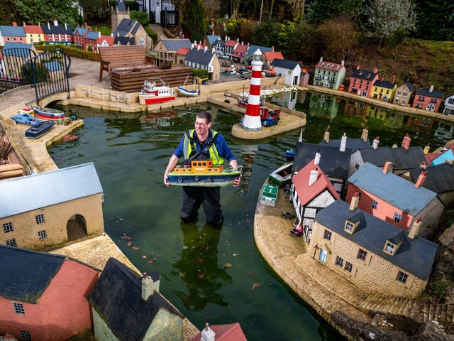 Arthur Watt, gardener and maintenance worker at Bondville Model Village, inspecting one of the model boats in the saftey of the harbour within the village.