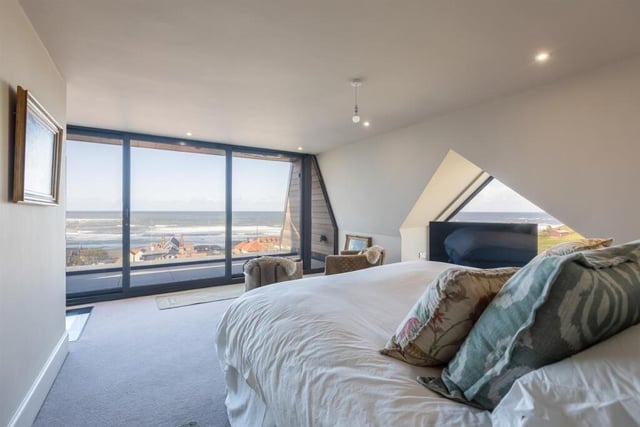 Luxury en suite bedrooms have incredible views - such as this one with its wall of windows.