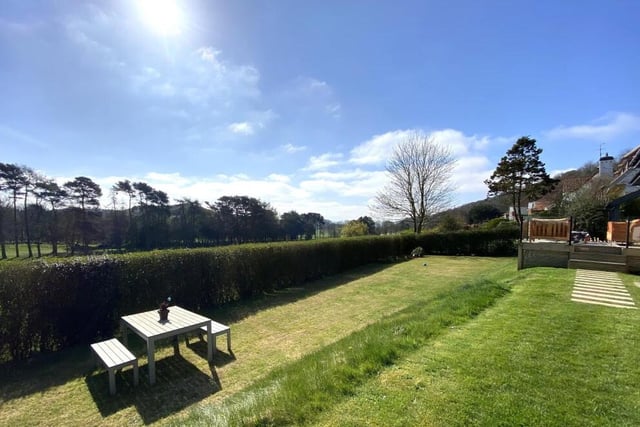 The rear lawned garden with seating areas.