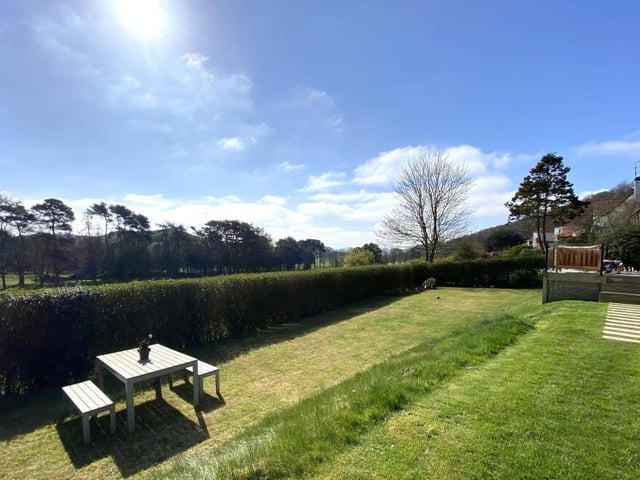 The rear lawned garden with seating areas.