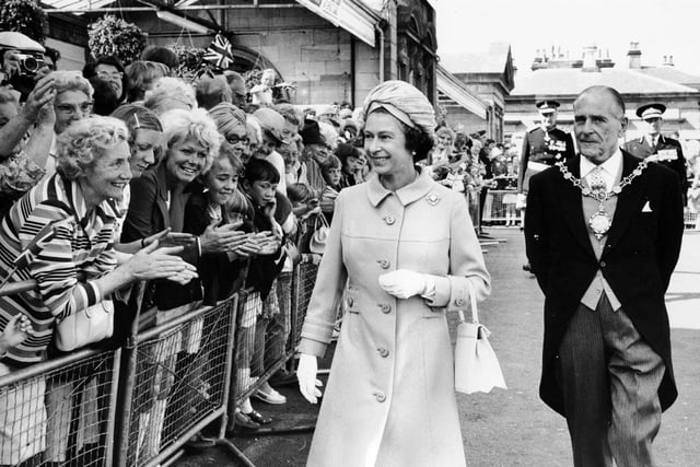 Queen Elizabeth II accompanied by the Mayor of Scarborough does a walkabout to meet people at Scarborough Railway Station in July 1975