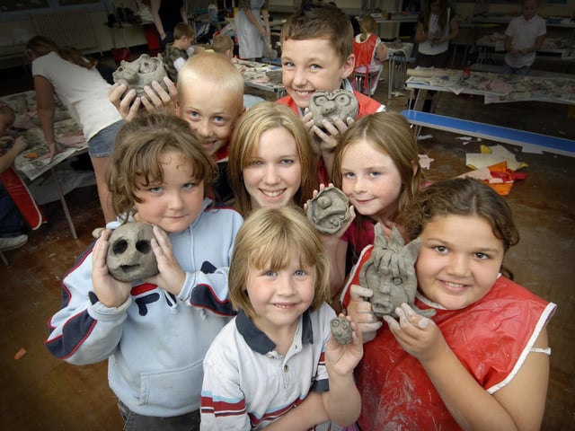Children show off their clay sculptures made at the Sure Start holiday activities week at Newby and Scalby School.